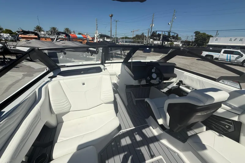Slide: The Image of Interior of 2026 Nautique Super Air Nautique G21 boat with white seating and modern dashboard. - 15