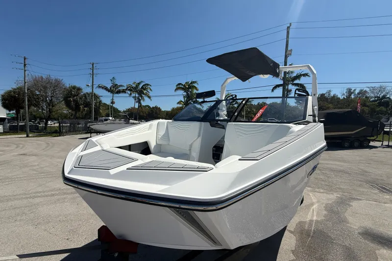 Slide: The Image of 2026 Nautique Super Air Nautique G21 boat with sleek design, parked outdoors under clear sky. - 20