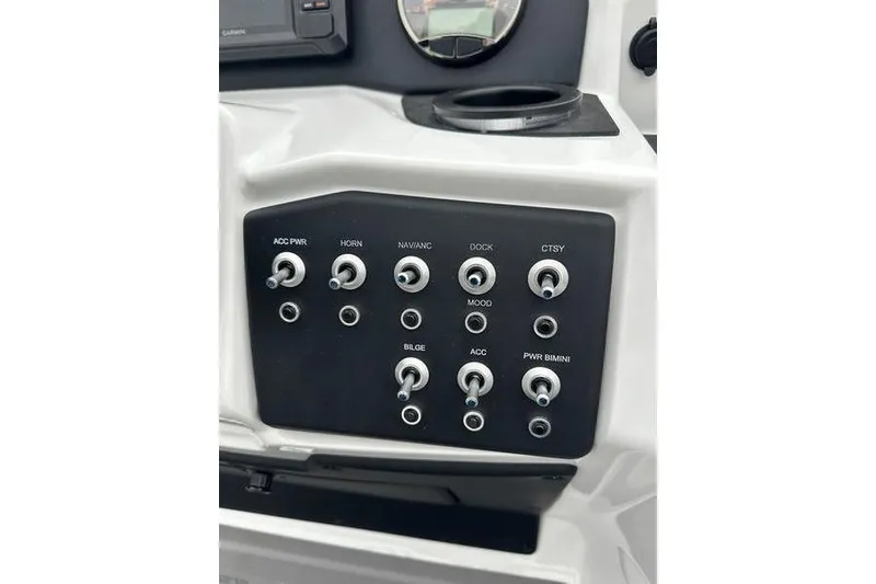 Slide: The Image of Control panel of 2026 EVOTTTI 523CS boat with various switches and dials. - 22