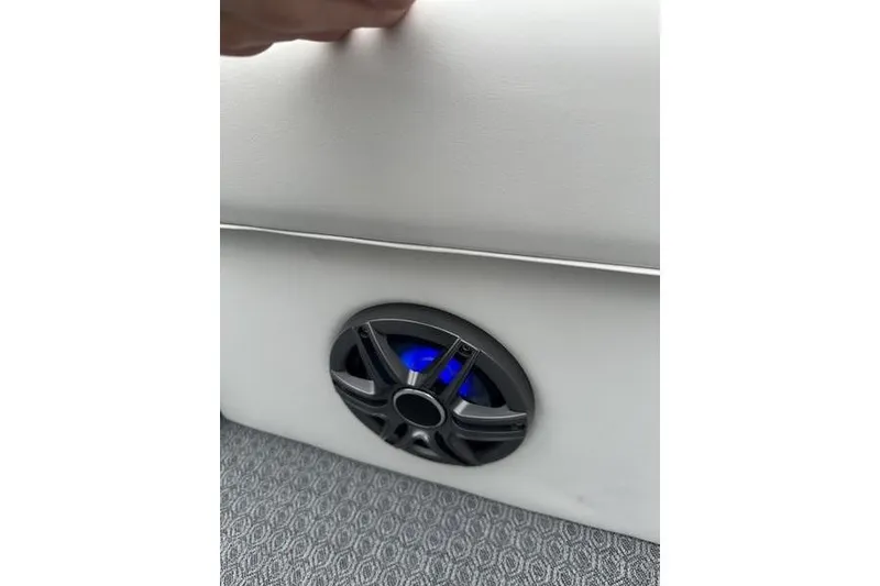 Slide: The Image of Interior of 2026 EVOTTTI 523CS with blue-lit speaker on white panel. - 24