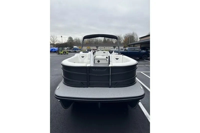 Slide: The Image of 2026 EVOTTTI 523CS pontoon boat, rear view in parking lot, overcast sky. - 5