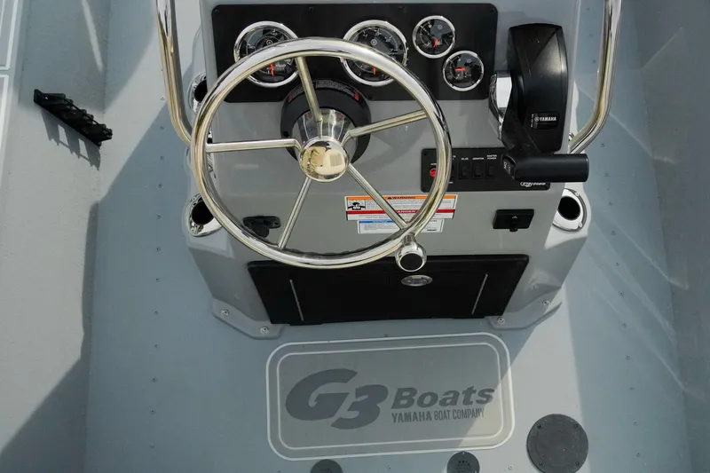 Slide: The Image of Steering console of 2026 G3 Bay 17 boat with gauges and controls. - 10
