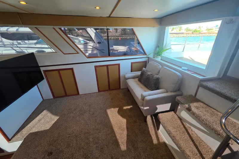 Slide: The Image of Interior of 1990 Novatec 44 Aft Cockpit Motor Yacht with cozy seating and large windows. - 10