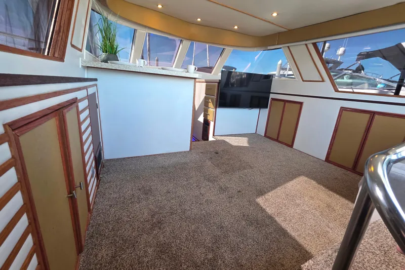 Slide: The Image of Interior of 1990 Novatec 44 Aft Cockpit Motor Yacht with carpeted floor and modern decor. - 11