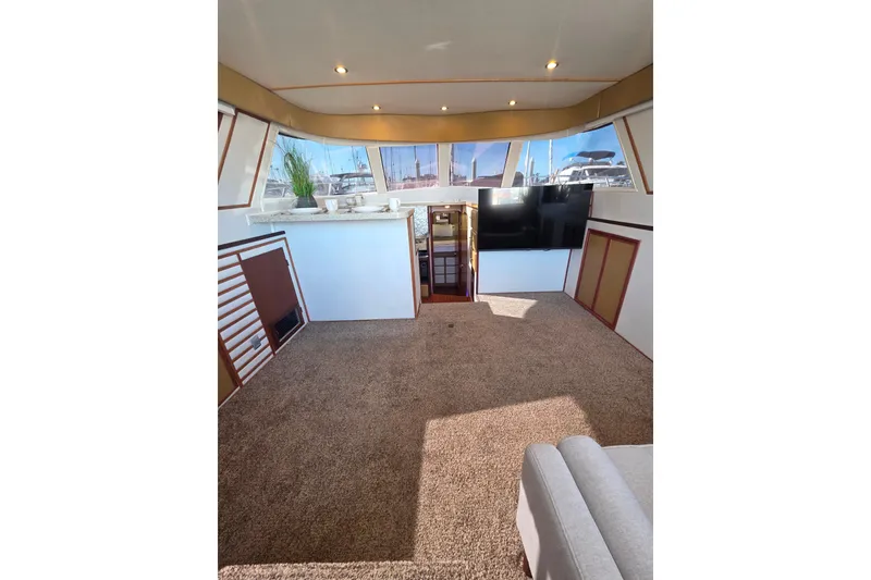 Slide: The Image of Interior of 1990 Novatec 44 Aft Cockpit Motor Yacht with carpet and large windows. - 12