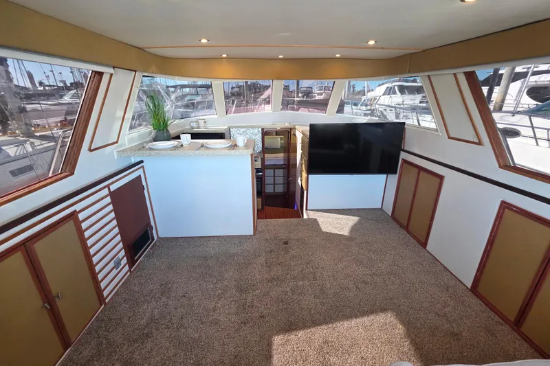 Slide: The Image of Interior of 1990 Novatec 44 Aft Cockpit Motor Yacht with modern decor and large windows. - 13