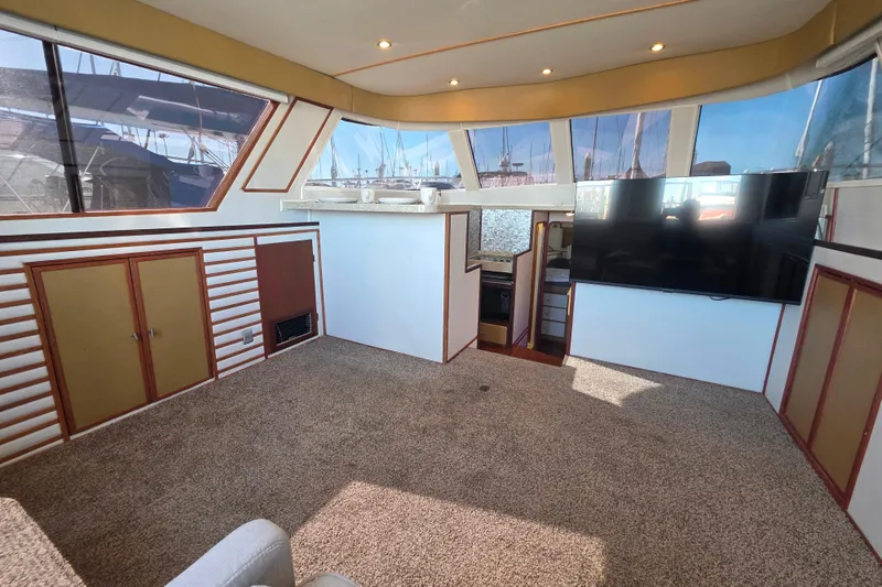 Slide: The Image of Interior of 1990 Novatec 44 Aft Cockpit Motor Yacht with large windows and TV. - 15