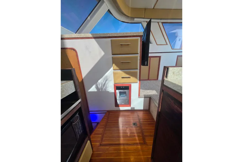 Slide: The Image of Interior of 1990 Novatec 44 Aft Cockpit Motor Yacht with wood flooring and cabinetry. - 21