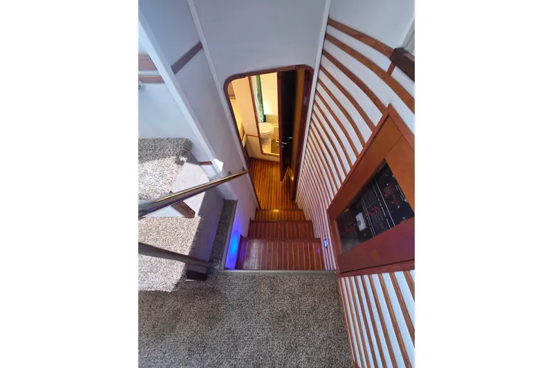 Slide: The Image of Interior view of 1990 Novatec 44 Aft Cockpit Motor Yacht with wooden stairs and modern design. - 25