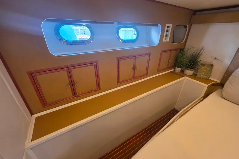 Slide: The Image of Interior of 1990 Novatec 44 Aft Cockpit Motor Yacht with portholes and storage cabinets. - 29