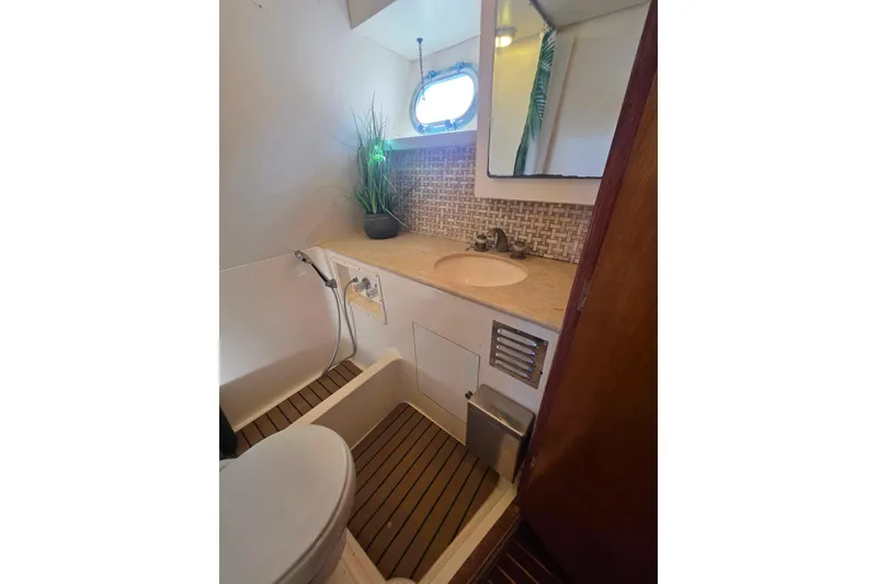 Slide: The Image of Bathroom interior of 1990 Novatec 44 Aft Cockpit Motor Yacht with sink and porthole. - 31