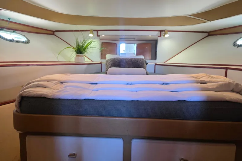 Slide: The Image of Cozy bedroom interior of 1990 Novatec 44 Aft Cockpit Motor Yacht with plush bedding. - 37