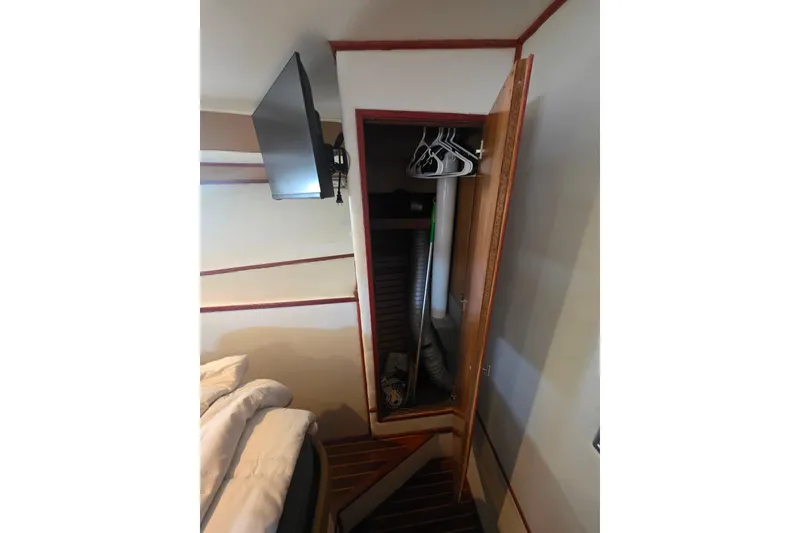 Slide: The Image of Interior of 1990 Novatec 44 Aft Cockpit Motor Yacht with open closet and TV. - 38