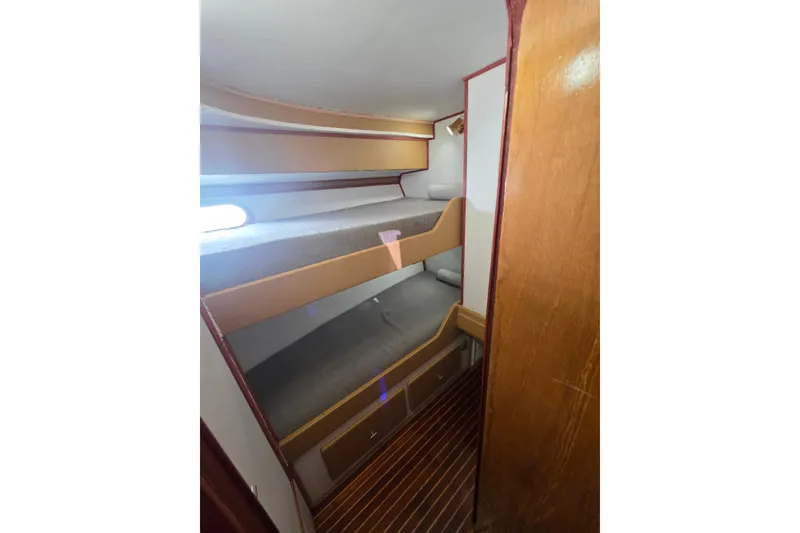 Slide: The Image of Interior of 1990 Novatec 44 Aft Cockpit Motor Yacht with bunk beds and wooden flooring. - 40