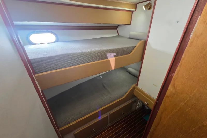 Slide: The Image of Bunk beds in 1990 Novatec 44 Aft Cockpit Motor Yacht cabin with porthole window. - 42