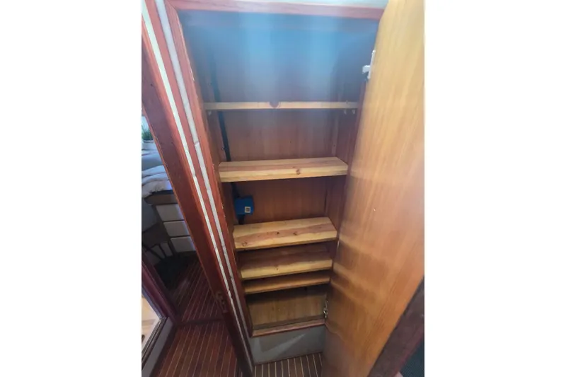 Slide: The Image of Wooden storage shelves inside 1990 Novatec 44 Aft Cockpit Motor Yacht. - 43