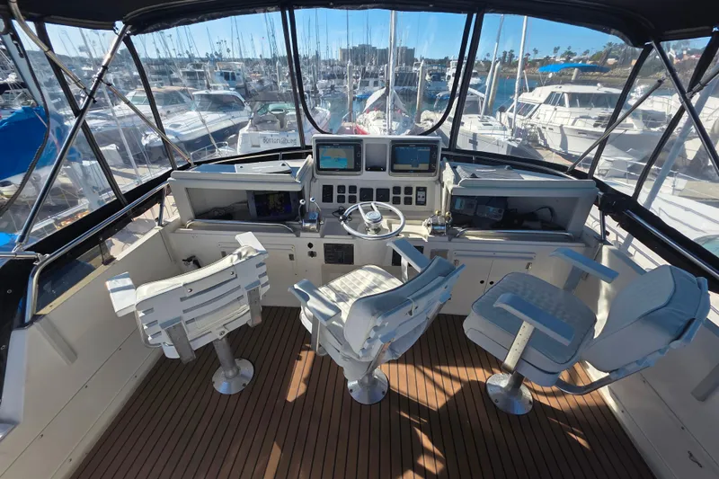 Slide: The Image of Cockpit of 1990 Novatec 44 Aft Cockpit Motor Yacht with steering wheel and navigation screens. - 44