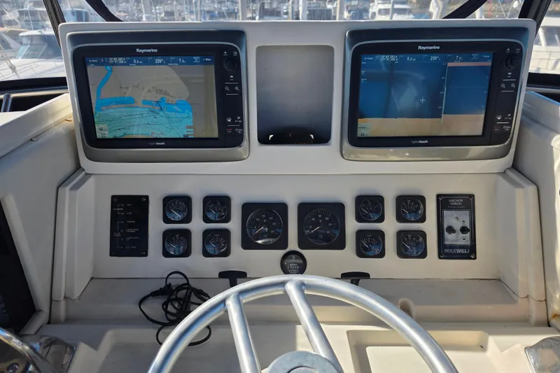 Slide: The Image of Control panel of a 1990 Novatec 44 Aft Cockpit Motor Yacht with navigation screens. - 48