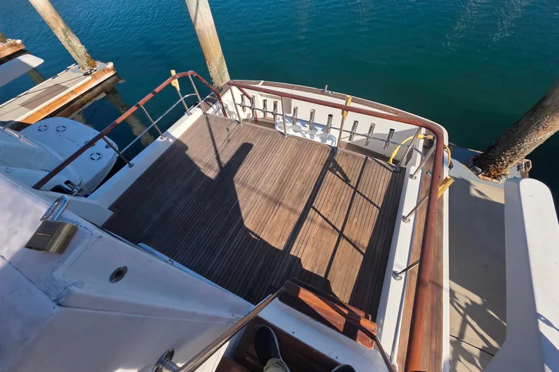 Slide: The Image of 1990 Novatec 44 Aft Cockpit Motor Yacht with wooden deck, docked at marina. - 51