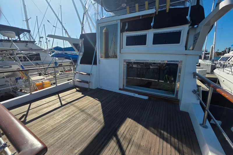 Slide: The Image of Novatec 44 Aft Cockpit Motor Yacht 1990, spacious deck, docked at marina. - 52