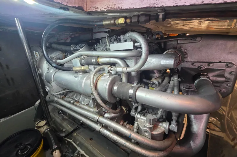 Slide: The Image of Engine compartment of a 1990 Novatec 44 Aft Cockpit Motor Yacht, showcasing intricate piping. - 56
