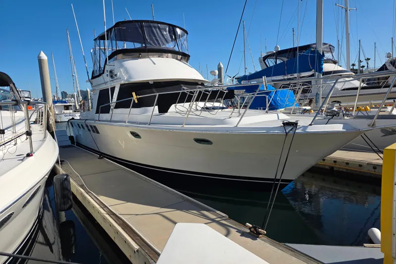 Slide: The Image of 1990 Novatec 44 Aft Cockpit Motor Yacht docked at marina under clear blue sky. - 7