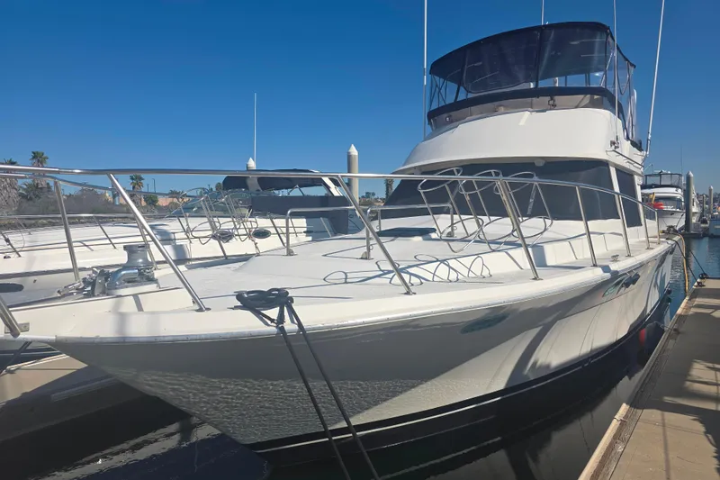 Slide: The Image of 1990 Novatec 44 Aft Cockpit Motor Yacht docked under clear blue sky. - 8