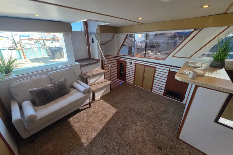 Slide: The Image of Interior of 1990 Novatec 44 Aft Cockpit Motor Yacht with cozy seating and nautical decor. - 9