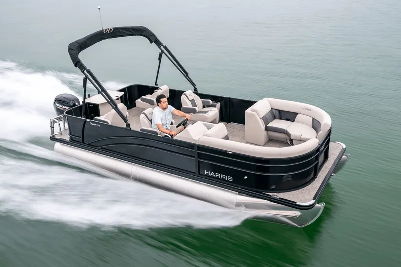 Slide: The Image of Harris Cruiser 210 pontoon boat 2026 on calm water. - 0