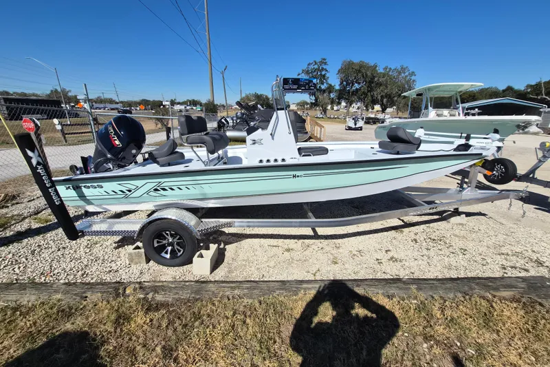 Slide: The Image of 2026 Xpress H20B Bay boat on trailer, outdoor display, sunny day. - 0