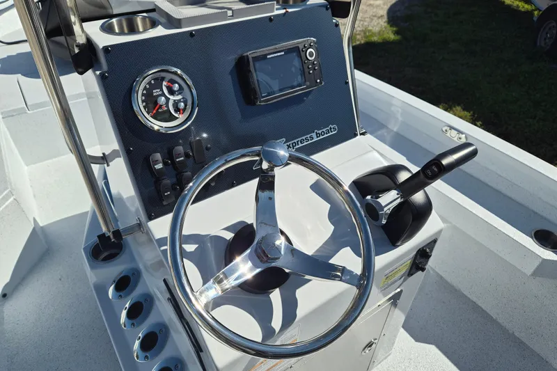 Slide: The Image of 2026 Xpress H20B Bay boat console with steering wheel and controls. - 3