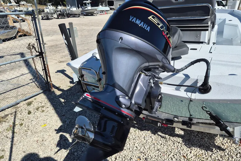 Slide: The Image of 2026 Xpress H20B Bay boat with Yamaha outboard motor in a marina setting. - 4