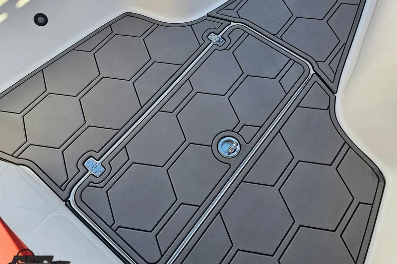 Slide: The Image of Hexagonal-patterned deck of 2025 Concept 27' CC boat, featuring sleek design and secure latch. - 101