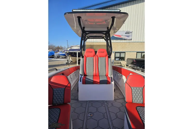 Slide: The Image of 2025 Concept 27' CC boat with red and gray seating, docked outdoors. - 106