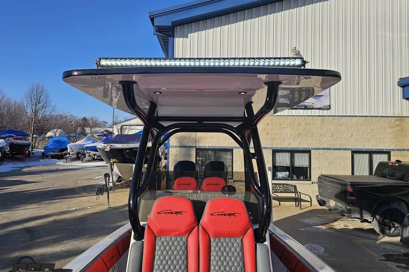 Slide: The Image of 2025 Concept 27' CC boat with red seats and T-top in a marina setting. - 109