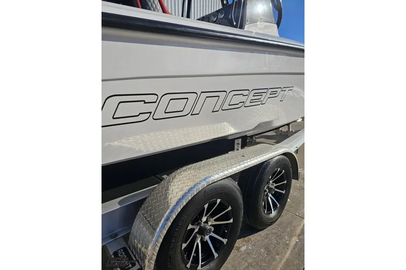 Slide: The Image of 2025 Concept 27' CC boat on trailer, showcasing sleek design and modern wheels. - 12
