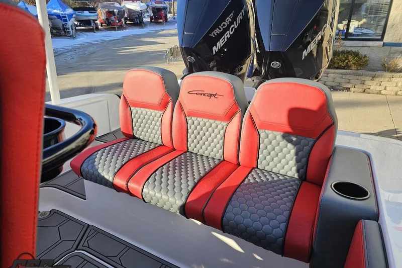 Slide: The Image of Red and gray seating on 2025 Concept 27' CC boat with Mercury engines in background. - 121