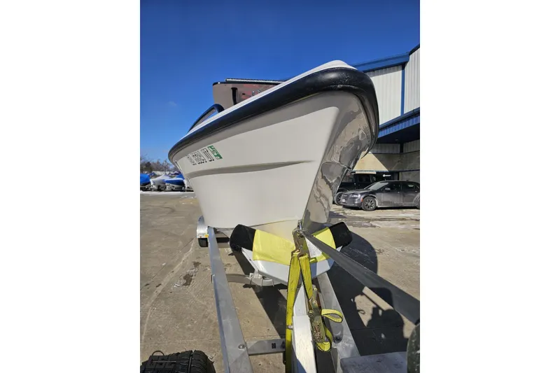 Slide: The Image of 2025 Concept 27' CC boat on trailer under clear blue sky. - 13