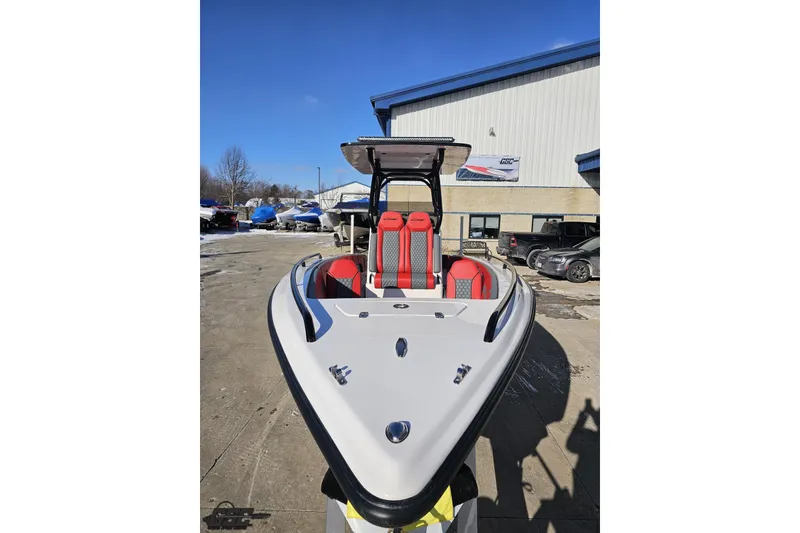 Slide: The Image of 2025 Concept 27' CC boat with red seats, docked outdoors under clear blue sky. - 14