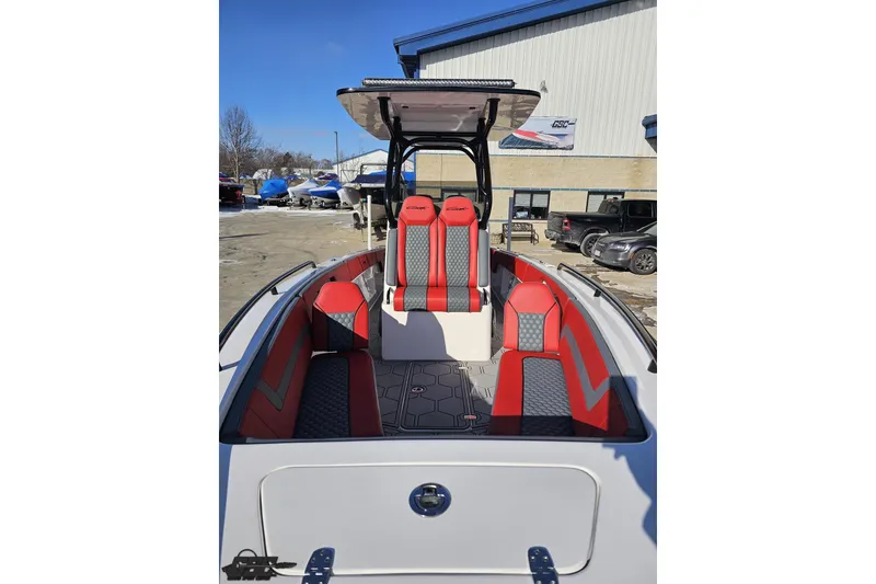 Slide: The Image of 2025 Concept 27' CC boat with red and gray seating, docked outdoors. - 15