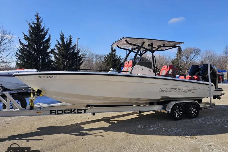 Slide: The Image of 2025 Concept 27' CC boat on Rocket trailer, parked outdoors under clear blue sky. - 17