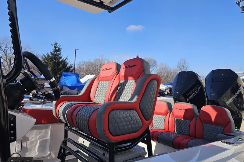 Slide: The Image of 2025 Concept 27' CC boat interior with red and gray seating, dual Mercury engines. - 22