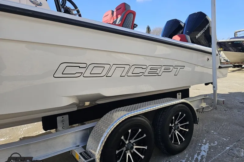 Slide: The Image of 2025 Concept 27' CC boat on trailer with dual Mercury engines. - 23
