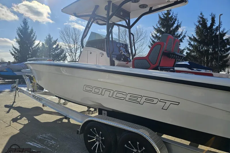 Slide: The Image of 2025 Concept 27' CC boat on trailer, sunny day, trees in background. - 26