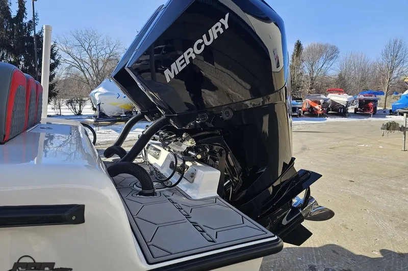 Slide: The Image of 2025 Concept 27' CC boat with Mercury outboard engine, docked outdoors. - 27