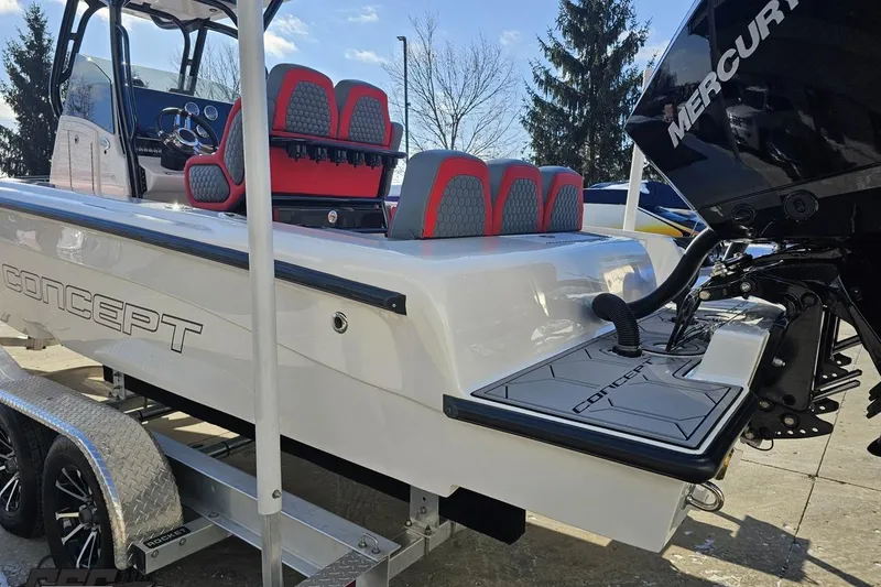 Slide: The Image of 2025 Concept 27' CC boat with red seats and Mercury engine on trailer. - 28