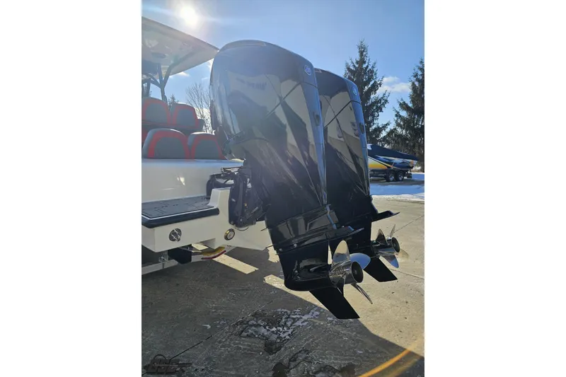 Slide: The Image of 2025 Concept 27' CC boat with dual outboard engines, parked on a sunny day. - 34