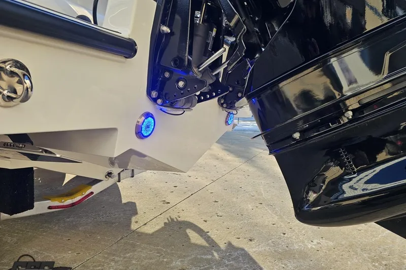 Slide: The Image of Rear view of 2025 Concept 27' CC boat with illuminated blue lights and sleek design. - 35