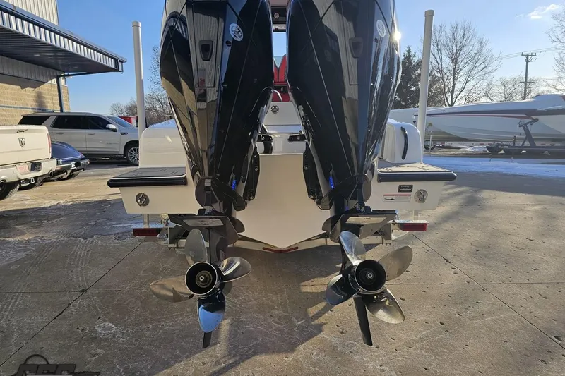 Slide: The Image of 2025 Concept 27' CC boat with dual outboard motors in a parking area. - 36