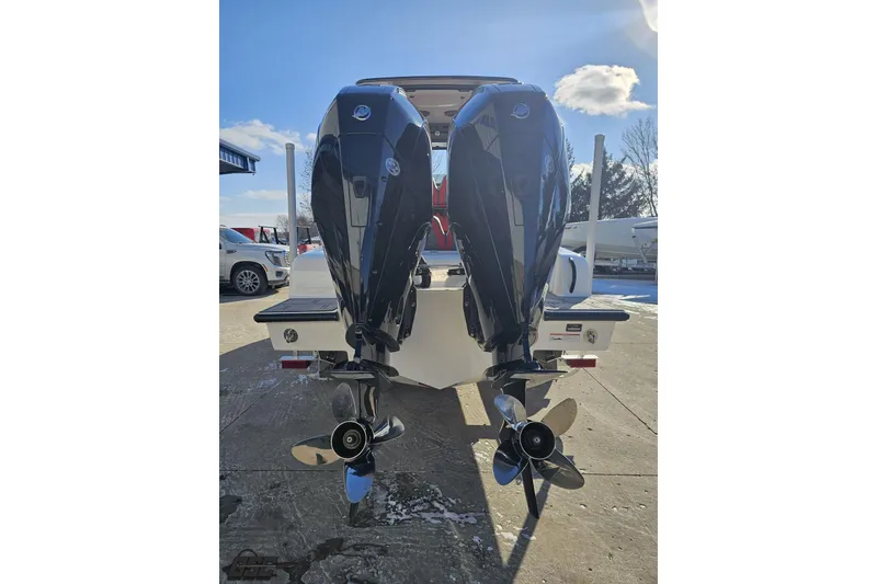 Slide: The Image of Twin outboard motors on a 2025 Concept 27' CC boat, sunny day background. - 37
